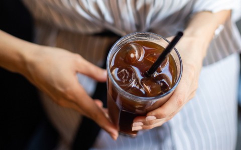 a woman drinking iced tea