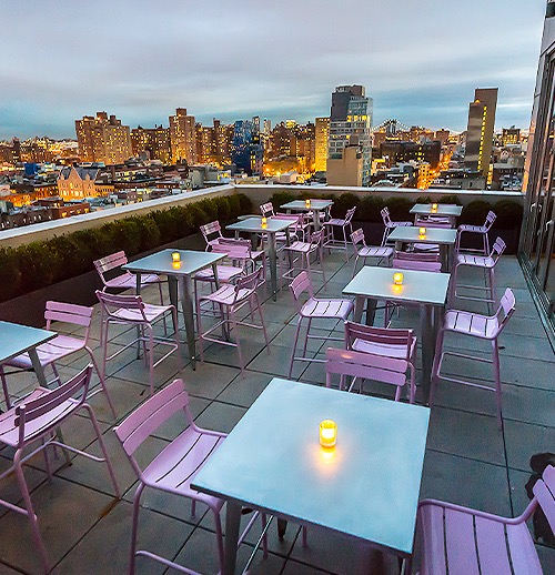 the rooftop with tables and purple chairs
