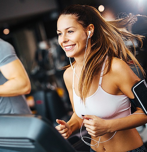 a woman running on a treadmill