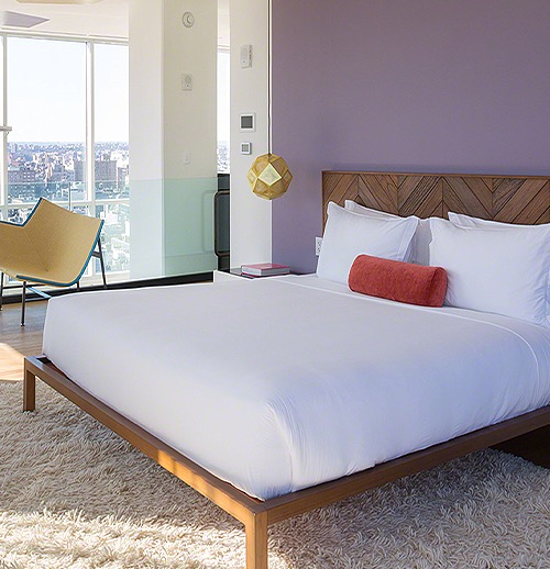 a hotel room with a purple wall 